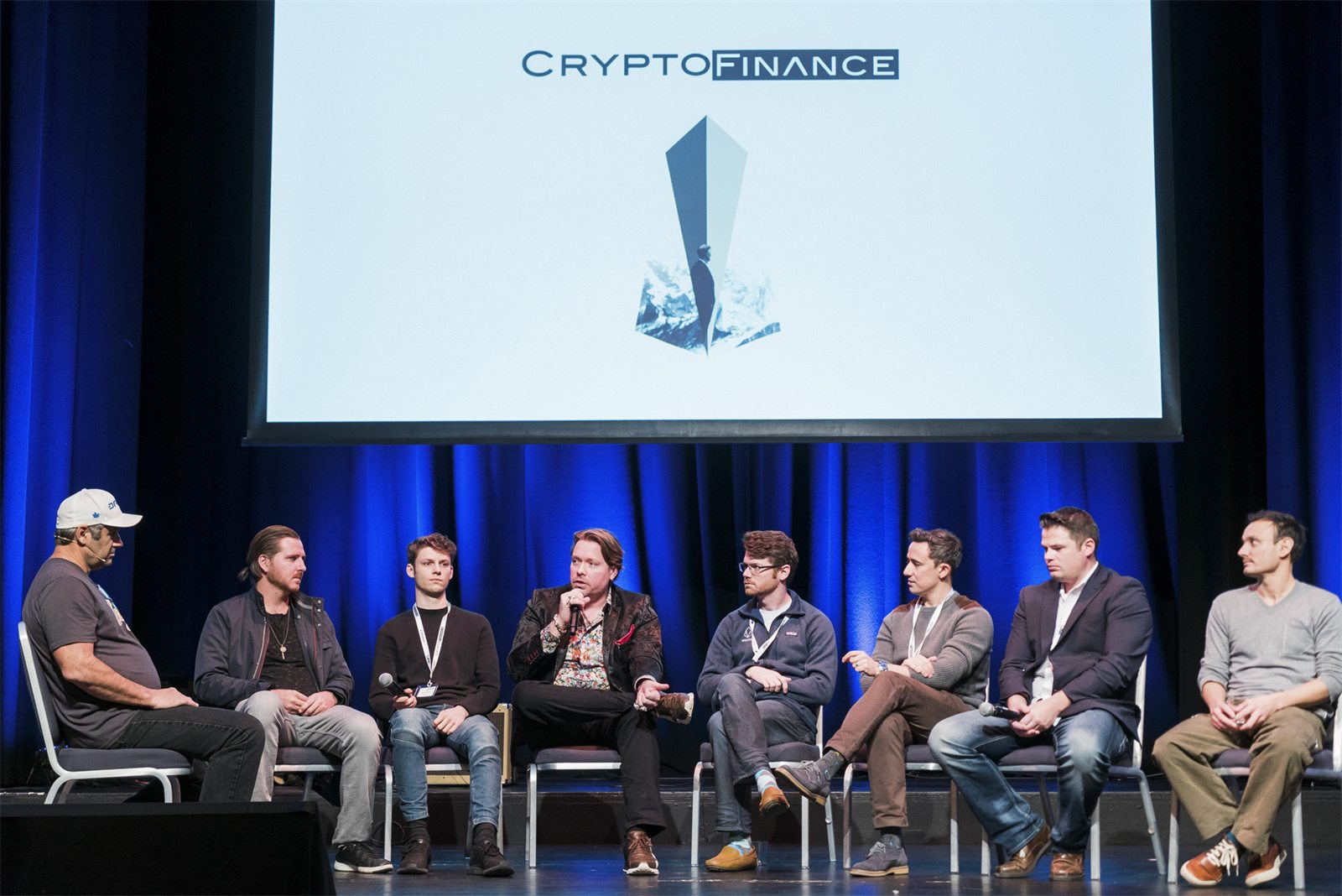 Speakers seated for a panel at CryptoFinance 2018